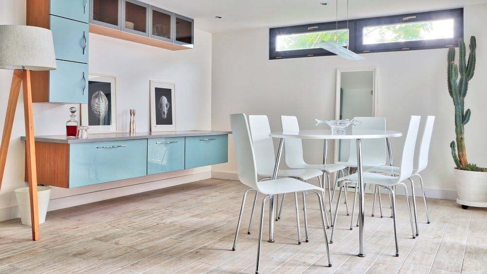 Self-contained garden studio lounge with high level windows