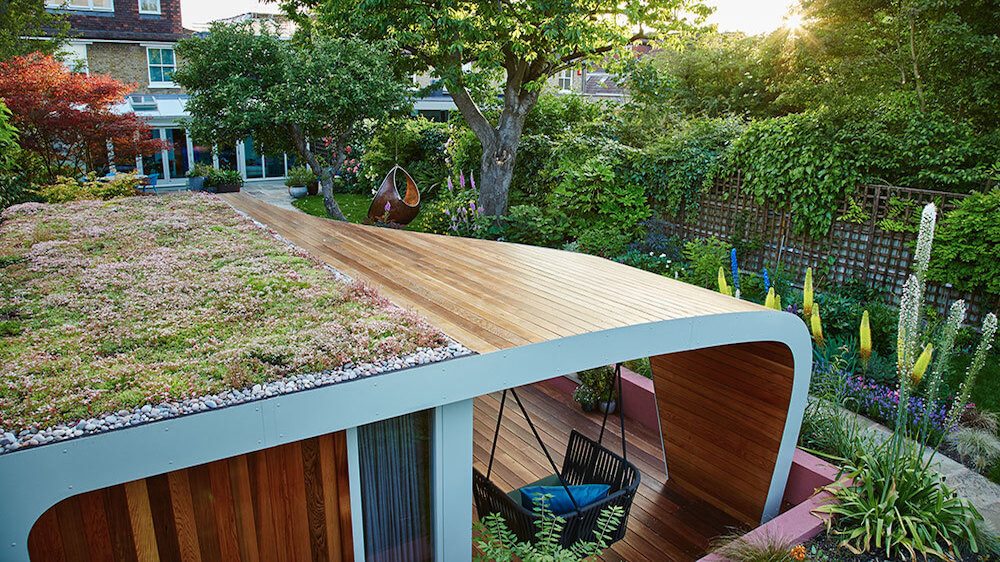 Bespoke garden room with green roof in bloom