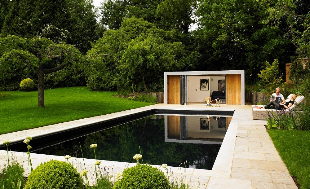 Garden poolside room with dark swimmingpool