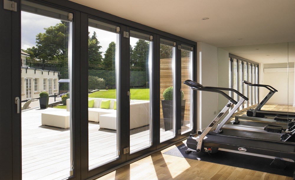 Bifolding double glazed doors for a garden gym by Rooms Outdoor